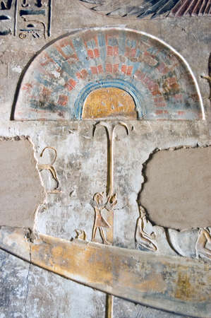 A coloured ancient Egyptian hieroglyphic carving showing a feather fan. Wall of the Temple of Medinet Habu on the west bank of the Nile at Luxor, Egypt.の写真素材