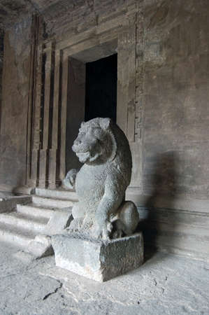 A large stone statue of a lion guarding one of the ancient Hindu temples in the caves on Elephanta Island off the coast of Mumbai, formerly Bombay, India.の写真素材