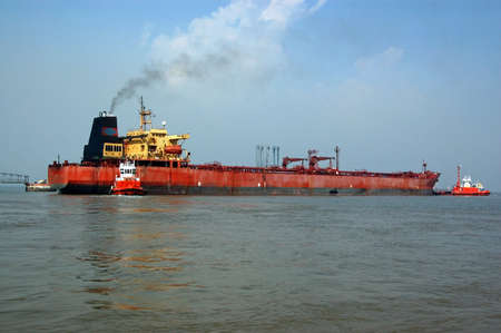 A huge tanker ship containing gas moored in the harbour of Mumbai off the Indian Ocean.の写真素材