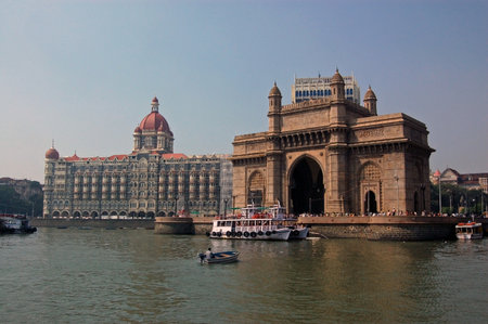 A view of the magnificent Gateway to India viewed from the harbour at Mumbai (formerly Bombay) with the Taj Hotel to the left hand side.のeditorial素材