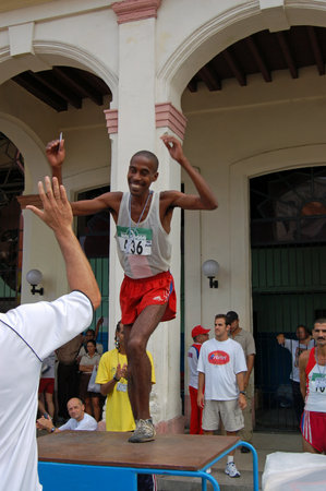 Havana, Cuba - November 20, 2005: Isbel MiliÃ¡n, winner of the men's race in the Marabana - Havana Marathon - getting onto the podium to collect his medal.のeditorial素材
