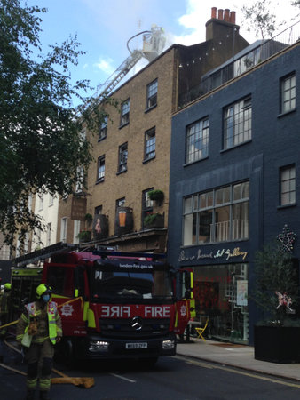 London, UK â June 23, 2021: Members of the London Fire Brigade tackling a fire at the Lore of the Land pub owned by director Guy Ritchie in the Fitzrovia district of Camden, London.のeditorial素材