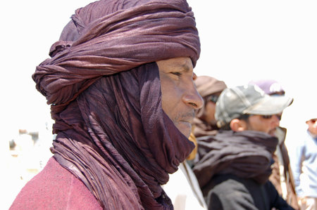 Waw al Kabir, Libya - March 29, 2006: A Tuareg driver wearing traditional robes to cope with the sun and sand in the Sahara Desert, Libya.のeditorial素材