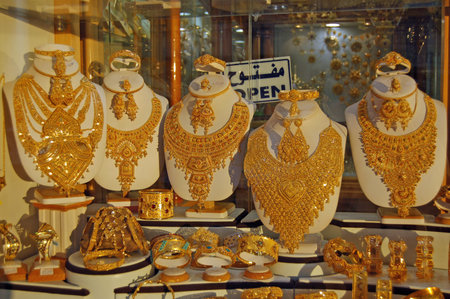 Misrata, Libya - April 1, 2006: Gold necklaces, bracelets, rings and earrings glistening in the evening sunshine in the window of a jewellery shop in the city of Misrata, Libya.のeditorial素材