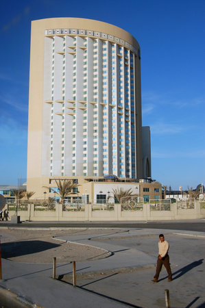 Tripoli, Libya - April 3, 2006: Pedestrians outside the landmark Corinthia Hotel in downtown Tripoli, Libya on a sunny day.  The hotel claimed five stars, but was poorly maintained.のeditorial素材