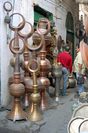 Tripoli, Libya - April 4, 2006:  Two men looking at the crafts on display at the metalwork bazaar in the old town of Tripoli, Libya.のeditorial素材