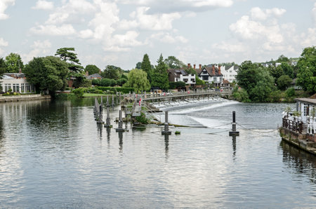 View from the suspension bridge of the weir on the River Thames at Marlow, Buckinghamshire on a sunny summer day.の写真素材