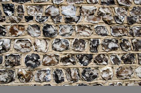 Close up view of napped flint stones forming a wall in historic Winchester, Hampshire.