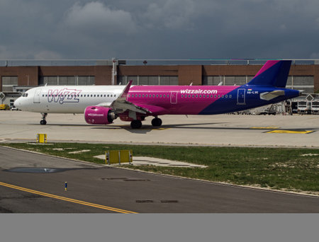Venice, Italy - April 19, 2022: A Wizz Air Airbus A321 waiting to take off from Marco Polo Airport in Venice, Italy on  a Spring morning with rain clouds in the distance.のeditorial素材