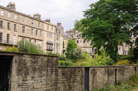 View from Royal Victoria Park of the rear elevations of some Georgian townhouses in the centre of Bath in Somerset on a late summer afternoon.の写真素材