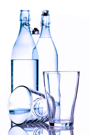 bottles and glasses of water on white backgroundの写真素材