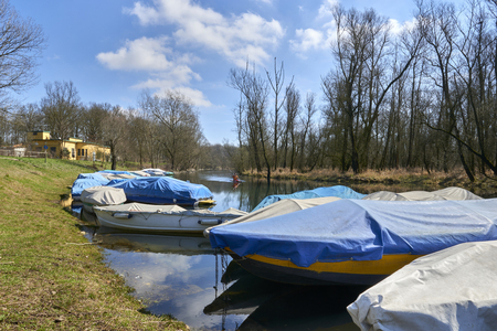 typical river boats moored and covered with rain clothsの写真素材