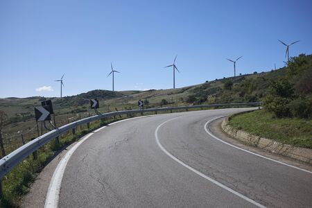 a road in central Sicily with wind farms in the backgroundの写真素材