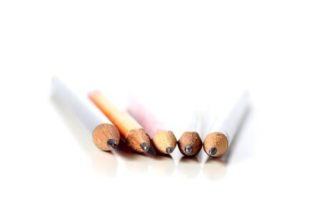 set of different colored used pencils on a white background