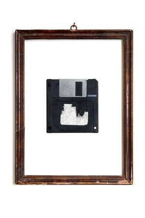 an old floppy disk in wooden frame isolated on white background