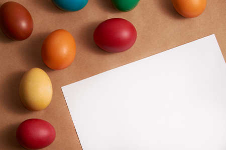 Colored Easter eggs on brown kitchen desk with copy spaceの写真素材