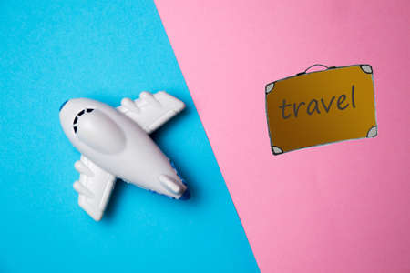 Flat lay design of travel concept with plane and travel bagの写真素材