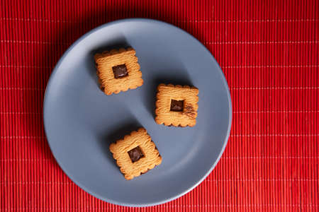 Stacked chocolate chip cookies on gray style plateの写真素材