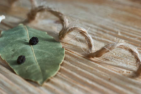 Black pepper and bayleaf on the wooden table. Dry Spices Mixの写真素材