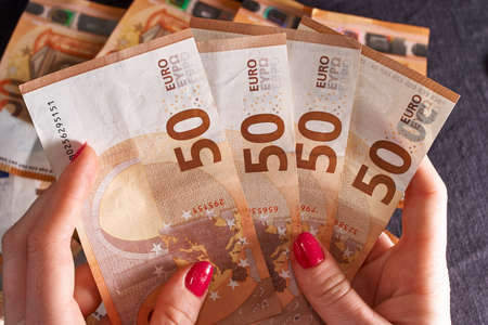hand with bitcoin and 50 fifty euros of backgrounds bills banknotes