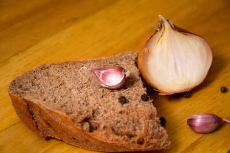 vegetables and rye bread, garlic and onion on table