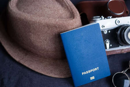 travel passport on gray background. sunglasses, hat. vintage camera on the background. EU visa free...