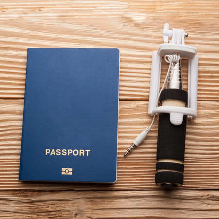 biometric passport with selfi stickon a wooden background with space, squareの写真素材