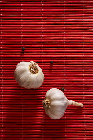 On the table, seasonings: garlic and black pepper peasの写真素材