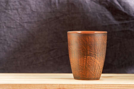 Clay cup of coffee on wooden table backgroundの写真素材