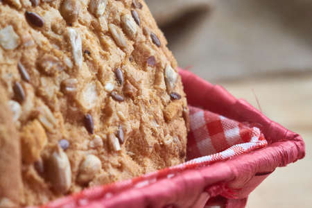 Savory cookies sprinkled with sesame seeds, sunflower on a wooden table and burlap background