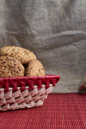 Cookies with sesame and sunflower seeds on wooden table and burlap background. Healthy eating