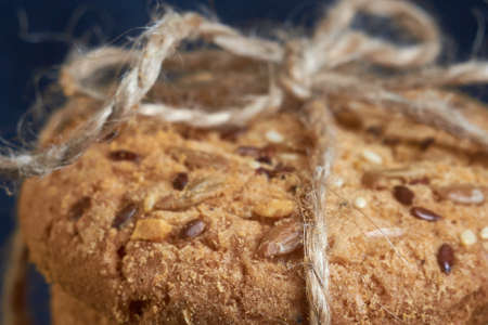 closeup oat large biscuits with sesame, flax and sunflower seeds. Macro, selective focus