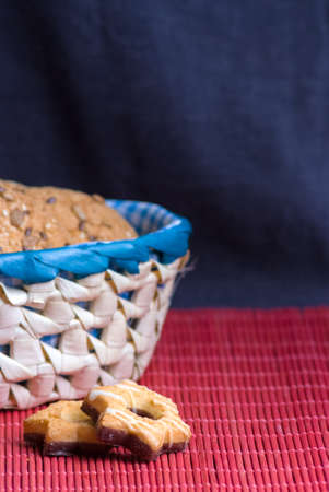 Savory cookies sprinkled with sesame seeds, sunflower on a wooden table and burlap background