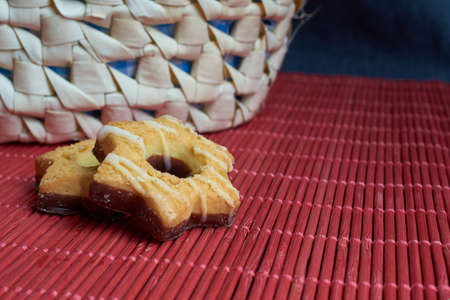 Savory cookies sprinkled with sesame seeds, sunflower on red background