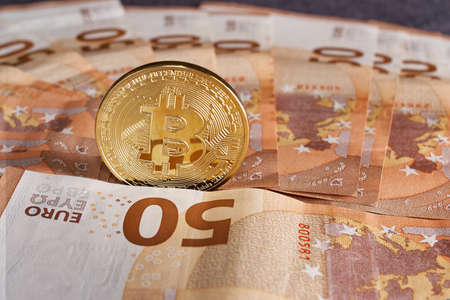 Golden bitcoin on fifty euro banknotes background. Bitcoin crypto currency, Blockchain technology, digital money, Mining conceptの写真素材