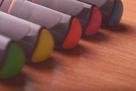 colored markers on the school table on wooden backgroundの写真素材