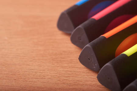 colored markers on the school table on wooden backgroundの写真素材