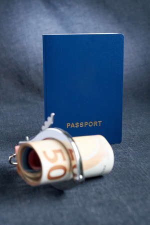 Blank blue passport background on gray background with from the euro in handcuffs. the concept lack...