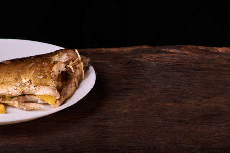 delicious roasted carp fish with lemon slices, spices, and fresh rosemary on baking sheet, view from aboveの写真素材