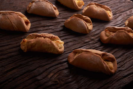 Baking cheesecakes with cottage cheese. blush baking on wooden table. sweet and tasty cookies