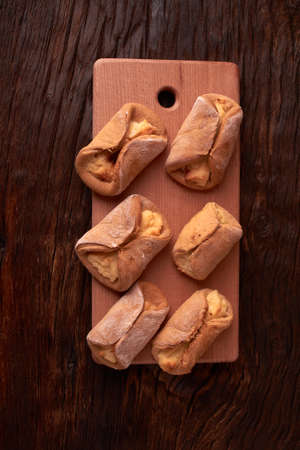 Cookies with Cottage cheese baked in oven, on wooden table and black background. Close up, selective focus.の写真素材