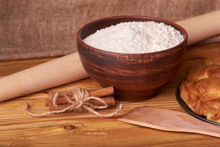apricot pie and a bowl with flour and other ingredients on wooden table