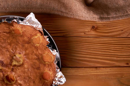 Apricot baked in foil on a wooden table