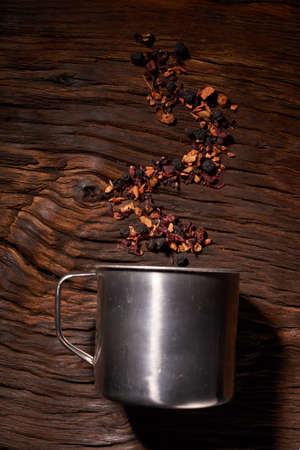 cup of tea with dried tea leaf on the wooden background