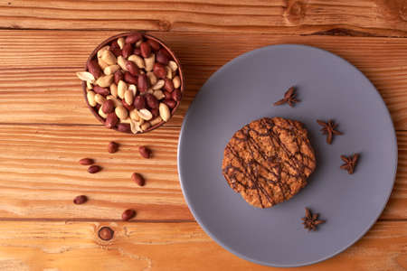walnut peanut in clay bowl. peanuts for food textures. peanut harvest. fried peanuts. texture of the nuts and chocolate cookies on plateの写真素材