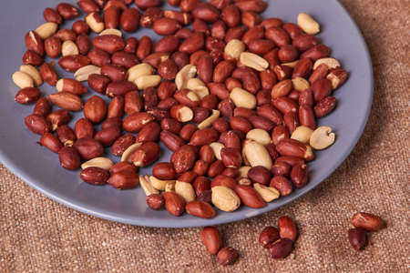 fried peanuts on blue plate on sackcloth