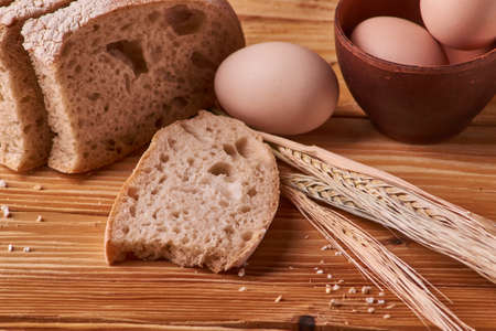fresh delicious bread, concept for baking. Eggs in clay bowl on wooden table