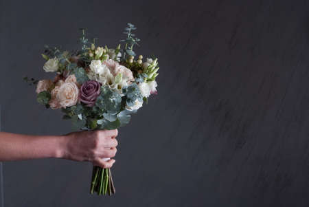 Buequet of white, pink and purple roses close up for bride