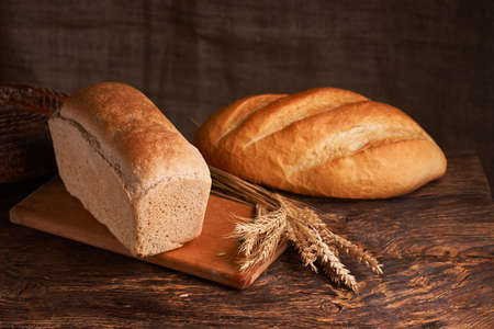 Bakery - gold rustic crusty loaves of bread and buns on black chalkboard background