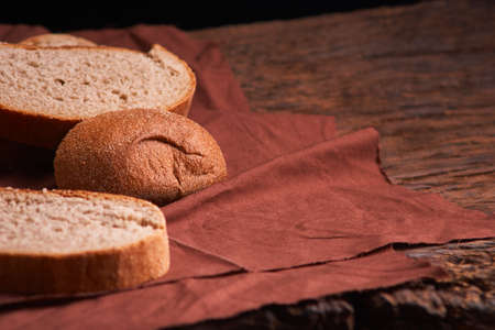 Bakery - gold rustic crusty loaves of bread and buns on black chalkboard backgroundの写真素材